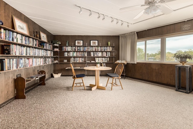 5540 Walnut Ave Unit 23C, Downers Grove, IL 60515 - home office with wooden walls, track lighting, ceiling fan, carpet flooring, and bookshelves