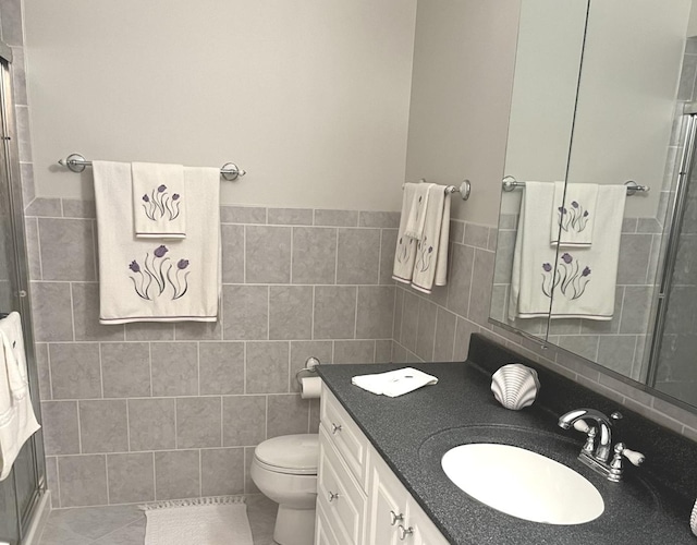 8001 W Courte Dr Unit 307, Niles, IL 60714 - bathroom with tile walls, vanity, toilet, a shower, and tile patterned flooring