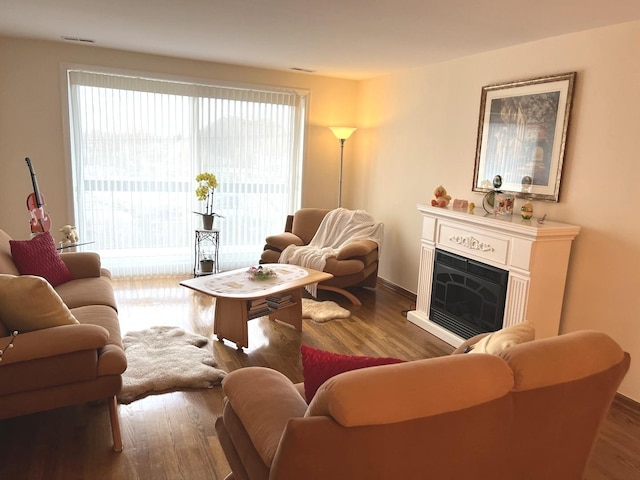 8001 W Courte Dr Unit 307, Niles, IL 60714 - living area featuring wood finished floors, a fireplace, and baseboards