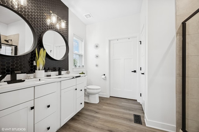 319 Carole St, Sugar Grove, IL 60554 - full bath with tiled shower, double vanity, toilet, wood finished floors, and tasteful backsplash