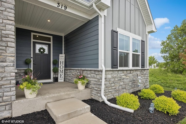 319 Carole St, Sugar Grove, IL 60554 - doorway to property featuring stone siding, board and batten siding, and covered porch