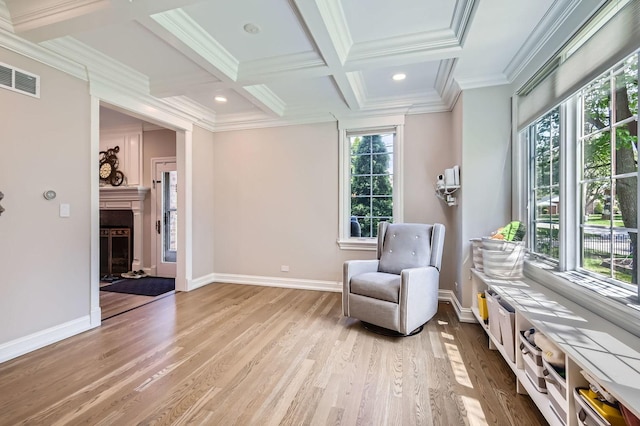 349 Home Ave, Itasca, IL 60143 - sitting room featuring light wood finished floors, a fireplace with raised hearth, ornamental molding, baseboards, and beam ceiling