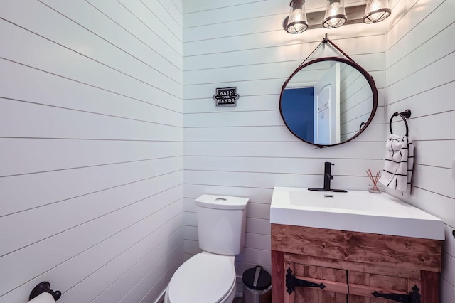 349 Home Ave, Itasca, IL 60143 - bathroom with toilet, vanity, and wood walls