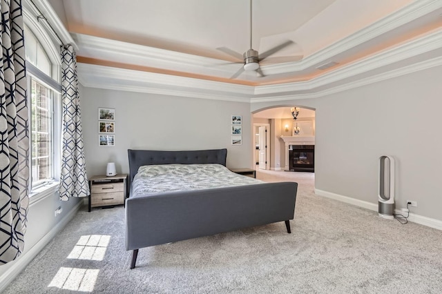 349 Home Ave, Itasca, IL 60143 - carpeted bedroom featuring arched walkways, a tray ceiling, ornamental molding, baseboards, and ceiling fan