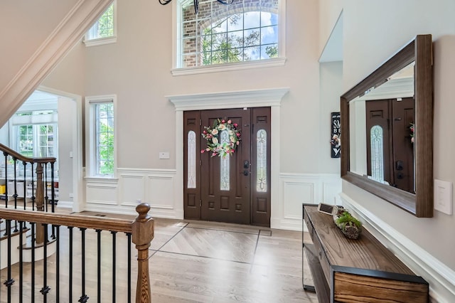 349 Home Ave, Itasca, IL 60143 - entrance foyer featuring a towering ceiling, wainscoting, a decorative wall, stairs, and wood finished floors