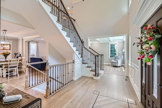 349 Home Ave, Itasca, IL 60143 - entryway with wood finished floors, crown molding, arched walkways, and stairs