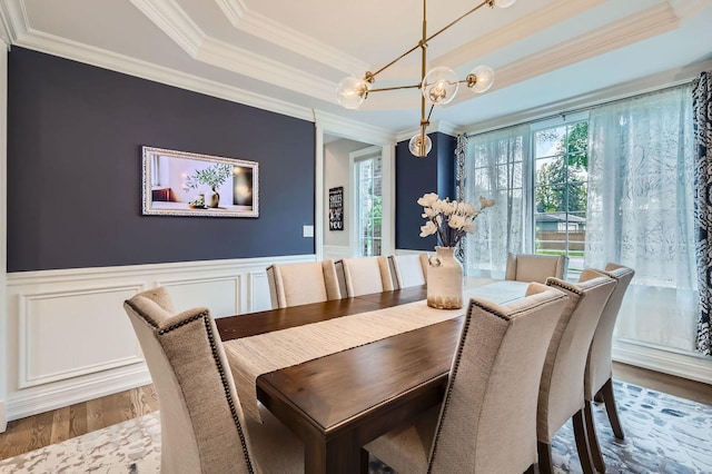 349 Home Ave, Itasca, IL 60143 - dining area featuring wood finished floors, a chandelier, crown molding, a raised ceiling, and wainscoting