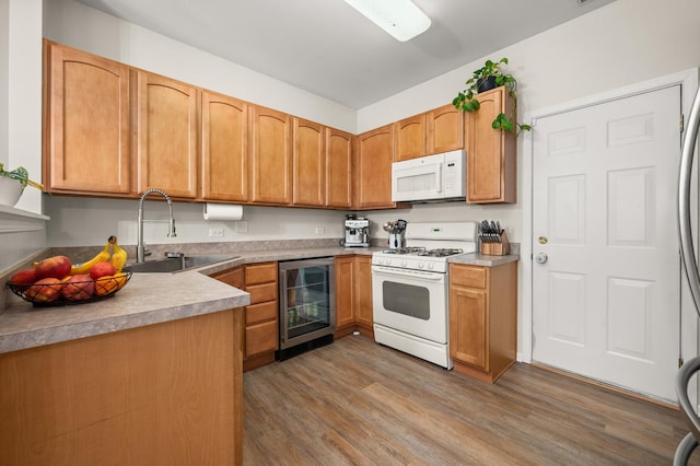 1481 Cambria Dr Unit 1, Dekalb, IL 60115 - kitchen featuring white appliances, beverage cooler, a sink, and wood finished floors