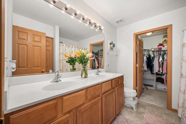 1481 Cambria Dr Unit 1, Dekalb, IL 60115 - full bathroom featuring double vanity, a spacious closet, and toilet