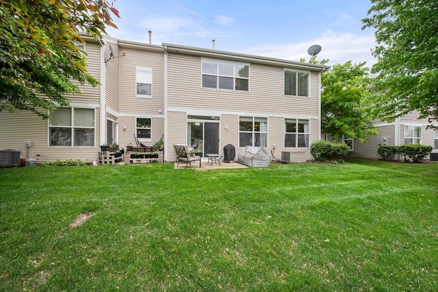 1481 Cambria Dr Unit 1, Dekalb, IL 60115 - rear view of house with central air condition unit, a patio, and a lawn