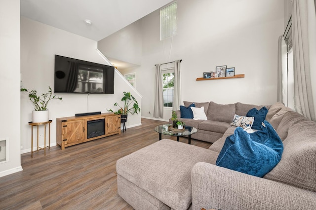 1481 Cambria Dr Unit 1, Dekalb, IL 60115 - living room featuring wood finished floors, baseboards, and a high ceiling