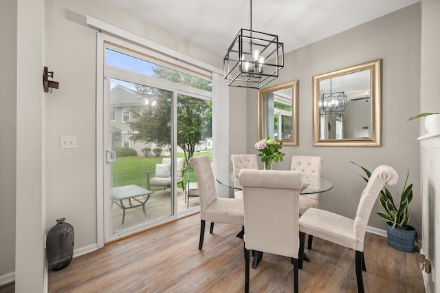 1481 Cambria Dr Unit 1, Dekalb, IL 60115 - dining room featuring a chandelier, wood finished floors, and baseboards