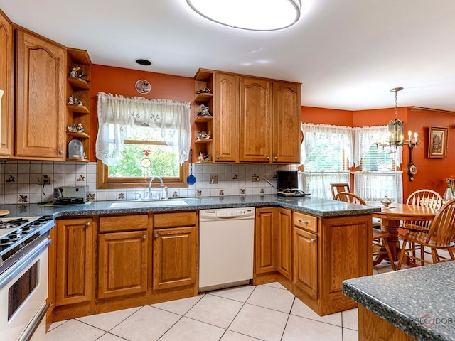 1010 Hampshire Ln, Elgin, IL 60120 - kitchen featuring white dishwasher, open shelves, a sink, range, and brown cabinetry