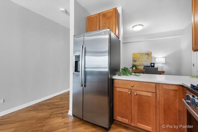 1212 N Wells St Unit 1403, Chicago, IL 60610 - kitchen featuring stainless steel appliances, wood finished floors, and brown cabinets
