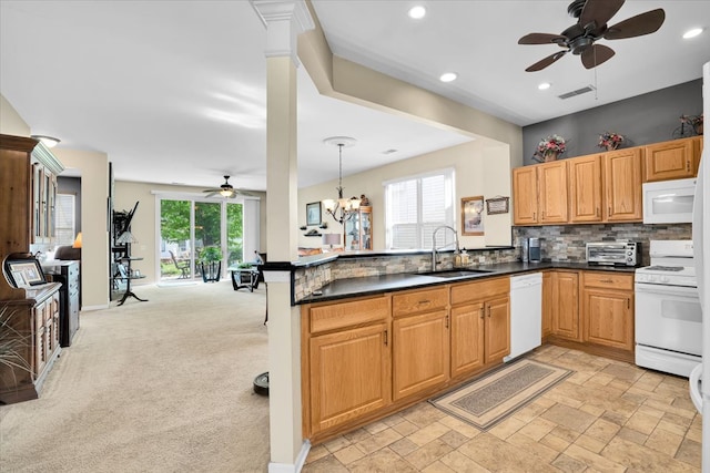 13569 Winterberry Ln, Huntley, IL 60142 - kitchen featuring white appliances, ceiling fan, a sink, a peninsula, and dark countertops