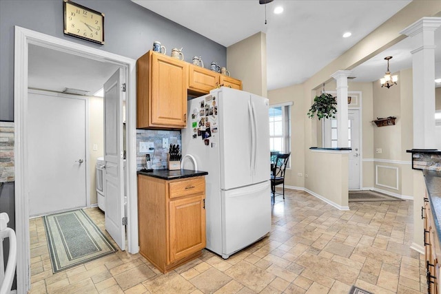 13569 Winterberry Ln, Huntley, IL 60142 - kitchen featuring freestanding refrigerator, decorative columns, stone tile flooring, tasteful backsplash, and dark countertops