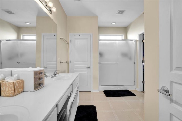 13569 Winterberry Ln, Huntley, IL 60142 - bathroom featuring a shower stall, healthy amount of natural light, double vanity, tile patterned floors, and recessed lighting