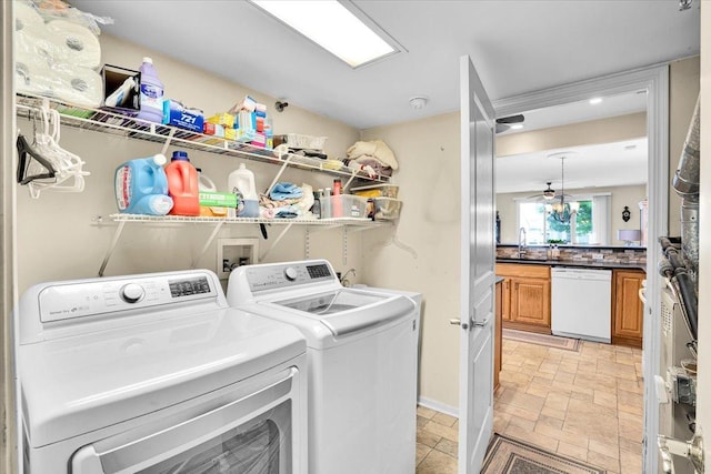 13569 Winterberry Ln, Huntley, IL 60142 - laundry room featuring washing machine and clothes dryer, a sink, recessed lighting, and light stone finish flooring