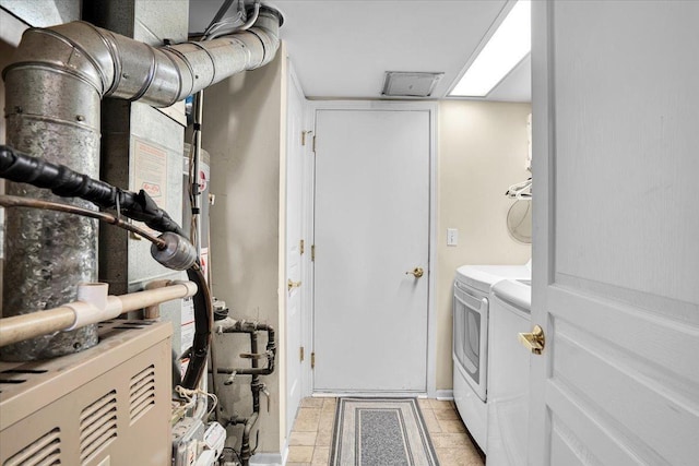 13569 Winterberry Ln, Huntley, IL 60142 - laundry room with washing machine and dryer, baseboards, and heating unit