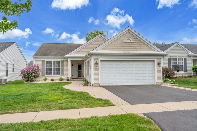 13569 Winterberry Ln, Huntley, IL 60142 - view of front facade with asphalt driveway, an attached garage, a front yard, and cooling unit