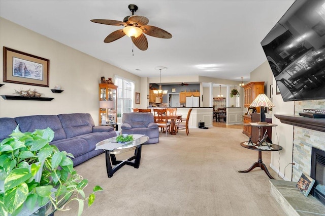 13569 Winterberry Ln, Huntley, IL 60142 - living room featuring a fireplace, a chandelier, light colored carpet, and ceiling fan