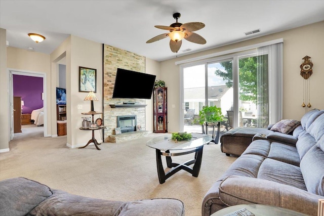 13569 Winterberry Ln, Huntley, IL 60142 - living area with ceiling fan, light carpet, a stone fireplace, and baseboards