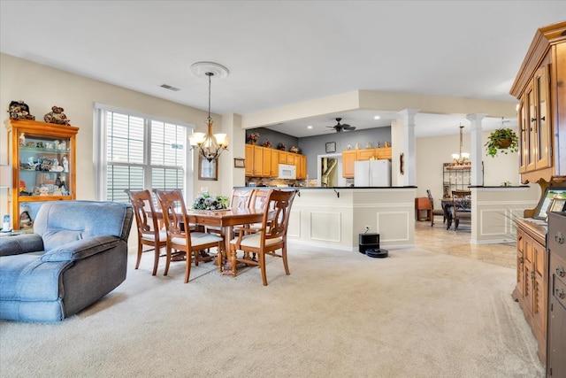 13569 Winterberry Ln, Huntley, IL 60142 - dining area with a chandelier, light colored carpet, ornate columns, and ceiling fan