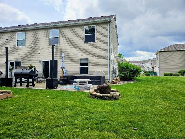 25159 Faraday Rd, Manhattan, IL 60442 - rear view of property with a patio, a lawn, and an outdoor fire pit