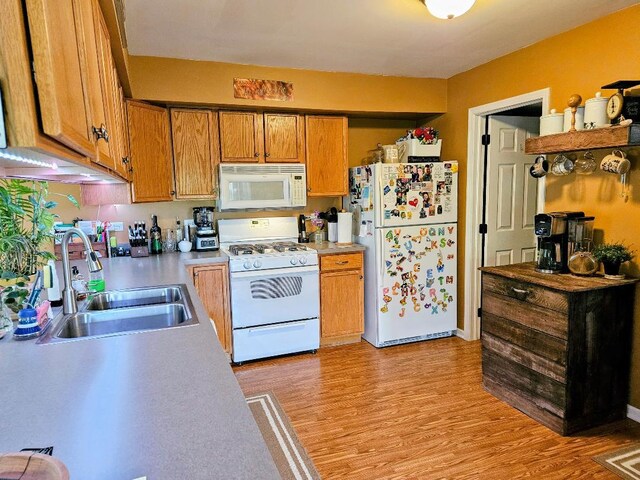 25159 Faraday Rd, Manhattan, IL 60442 - kitchen featuring white appliances, a sink, light wood-type flooring, brown cabinets, and light countertops