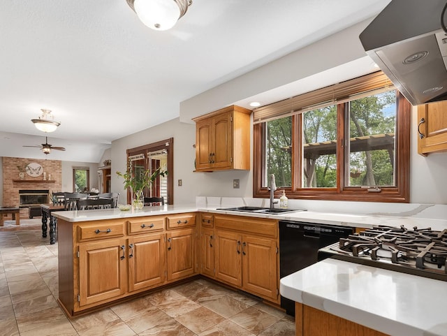 279 N Division St, Braidwood, IL 60408 - kitchen featuring a peninsula, light countertops, a brick fireplace, and exhaust hood