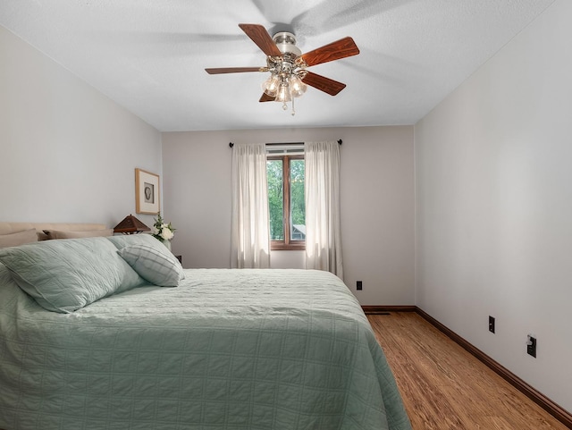 279 N Division St, Braidwood, IL 60408 - bedroom with wood finished floors, ceiling fan, and baseboards