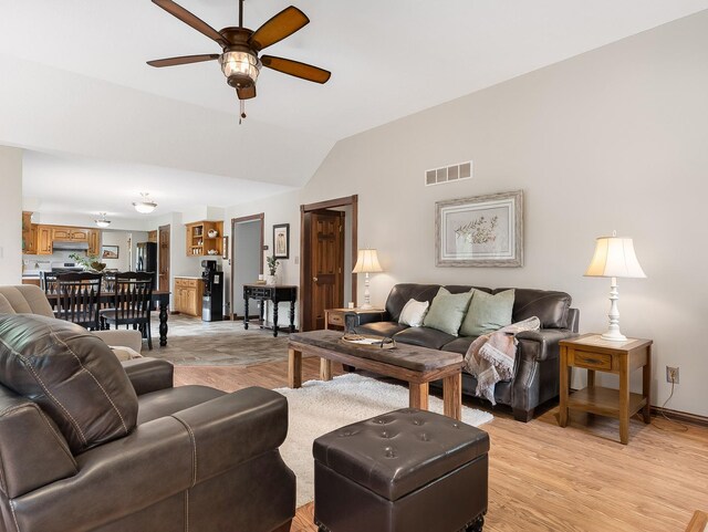 279 N Division St, Braidwood, IL 60408 - living area with a ceiling fan, vaulted ceiling, light wood finished floors, and baseboards