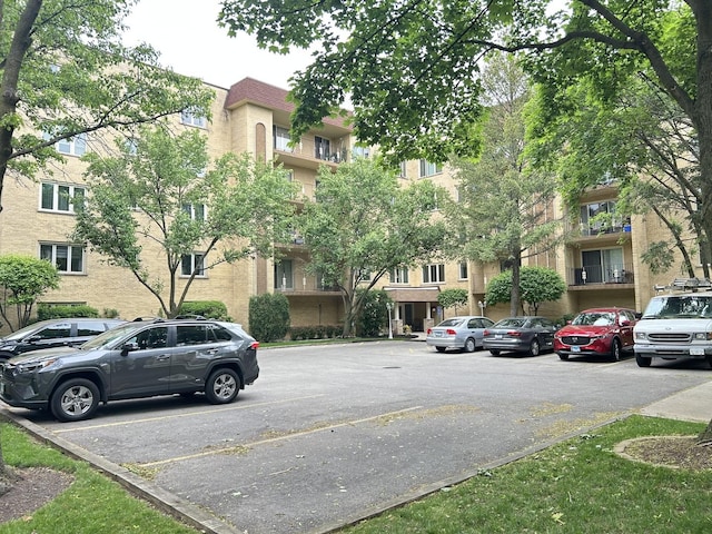 view of building exterior with uncovered parking