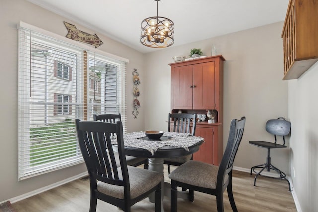 1034 Willoby Ln, Elgin, IL 60120 - dining space featuring light wood-style flooring, a chandelier, and baseboards