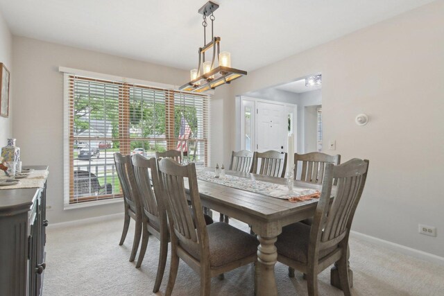 1034 Willoby Ln, Elgin, IL 60120 - dining room with light carpet, baseboards, and a chandelier