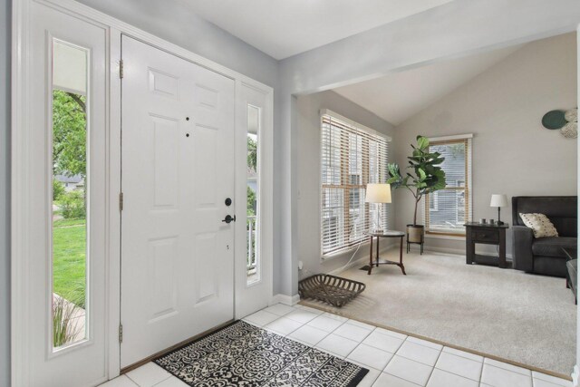 1034 Willoby Ln, Elgin, IL 60120 - foyer with light carpet, vaulted ceiling, light tile patterned flooring, and baseboards