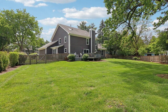 1034 Willoby Ln, Elgin, IL 60120 - rear view of house with a chimney and a wooden deck