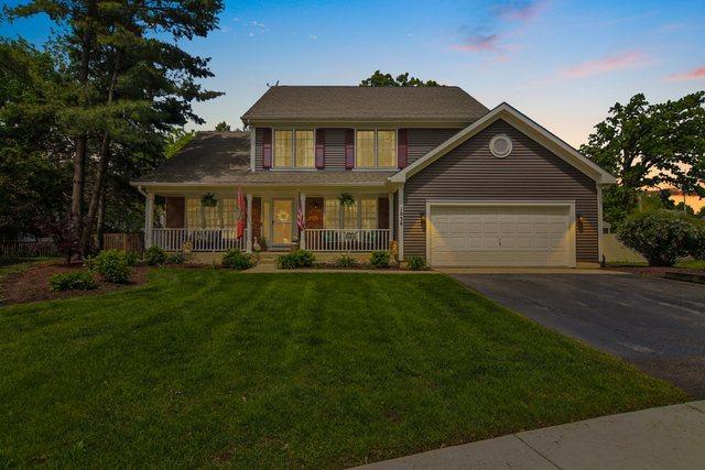 1034 Willoby Ln, Elgin, IL 60120 - view of front of home with a porch, driveway, a front yard, and an attached garage