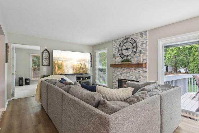1034 Willoby Ln, Elgin, IL 60120 - living room with a fireplace, wood finished floors, and baseboards