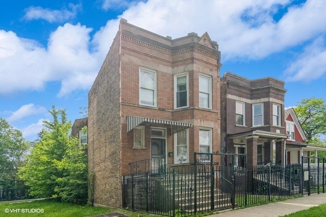6151 S Marshfield Ave, Chicago, IL 60636 - view of front facade with brick siding and a fenced front yard