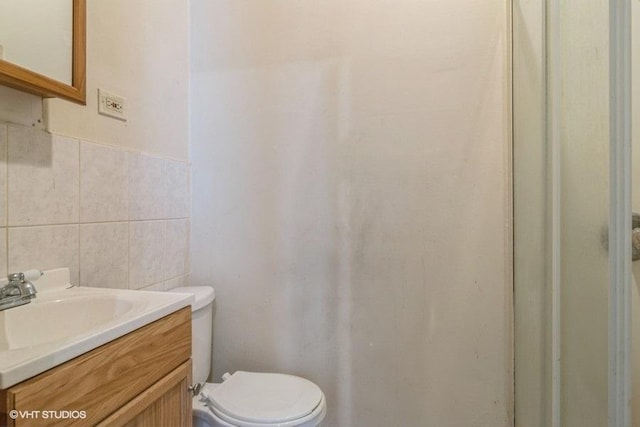 6151 S Marshfield Ave, Chicago, IL 60636 - bathroom with toilet, tile walls, and vanity