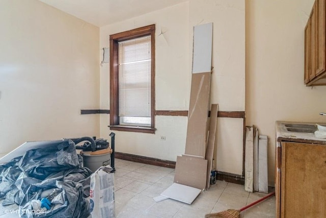 6151 S Marshfield Ave, Chicago, IL 60636 - kitchen featuring radiator heating unit, healthy amount of natural light, a sink, and brown cabinets
