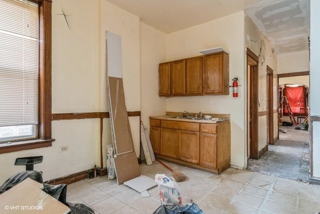 6151 S Marshfield Ave, Chicago, IL 60636 - kitchen featuring brown cabinets, a sink, and light countertops