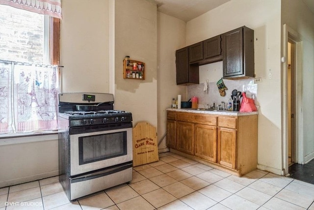 6151 S Marshfield Ave, Chicago, IL 60636 - kitchen with stainless steel range with gas stovetop, light countertops, healthy amount of natural light, and decorative backsplash