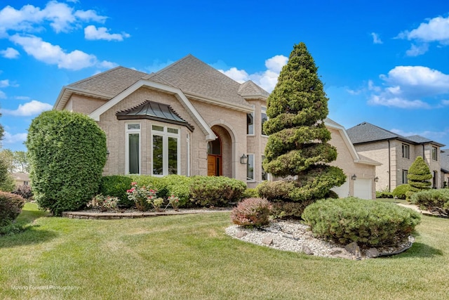 1773 W Whispering Ct, Addison, IL 60101 - french country inspired facade featuring brick siding, roof with shingles, a front yard, and a garage
