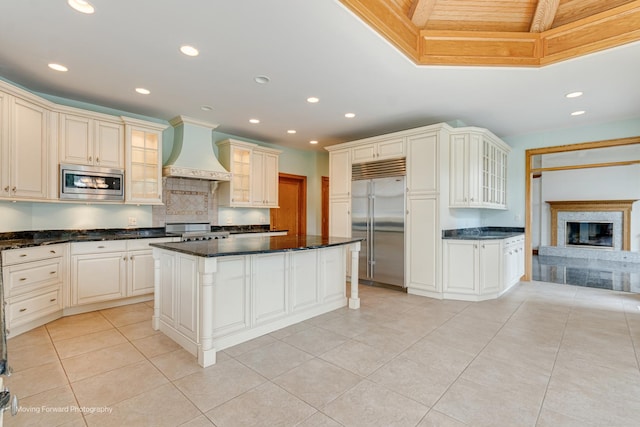 1773 W Whispering Ct, Addison, IL 60101 - kitchen featuring built in appliances, custom exhaust hood, decorative backsplash, glass insert cabinets, and light tile patterned floors