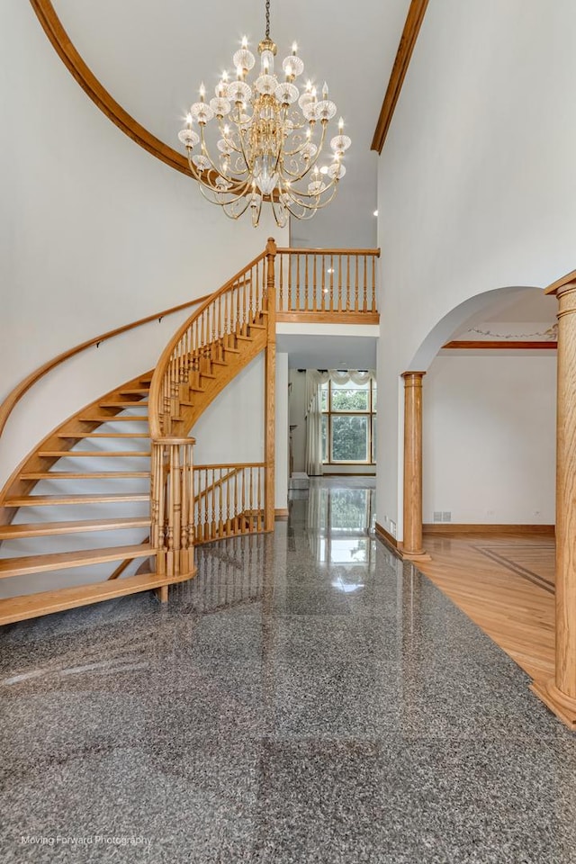 1773 W Whispering Ct, Addison, IL 60101 - stairway with a high ceiling, arched walkways, granite floors, decorative columns, and a chandelier