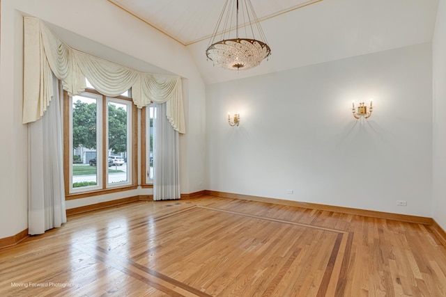 1773 W Whispering Ct, Addison, IL 60101 - empty room featuring lofted ceiling, light wood-type flooring, and a chandelier