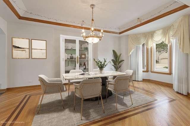 1773 W Whispering Ct, Addison, IL 60101 - dining space with a chandelier, a tray ceiling, and light wood-type flooring