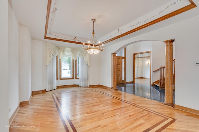 1773 W Whispering Ct, Addison, IL 60101 - spare room with arched walkways, wood finished floors, a raised ceiling, a chandelier, and inlaid floor details